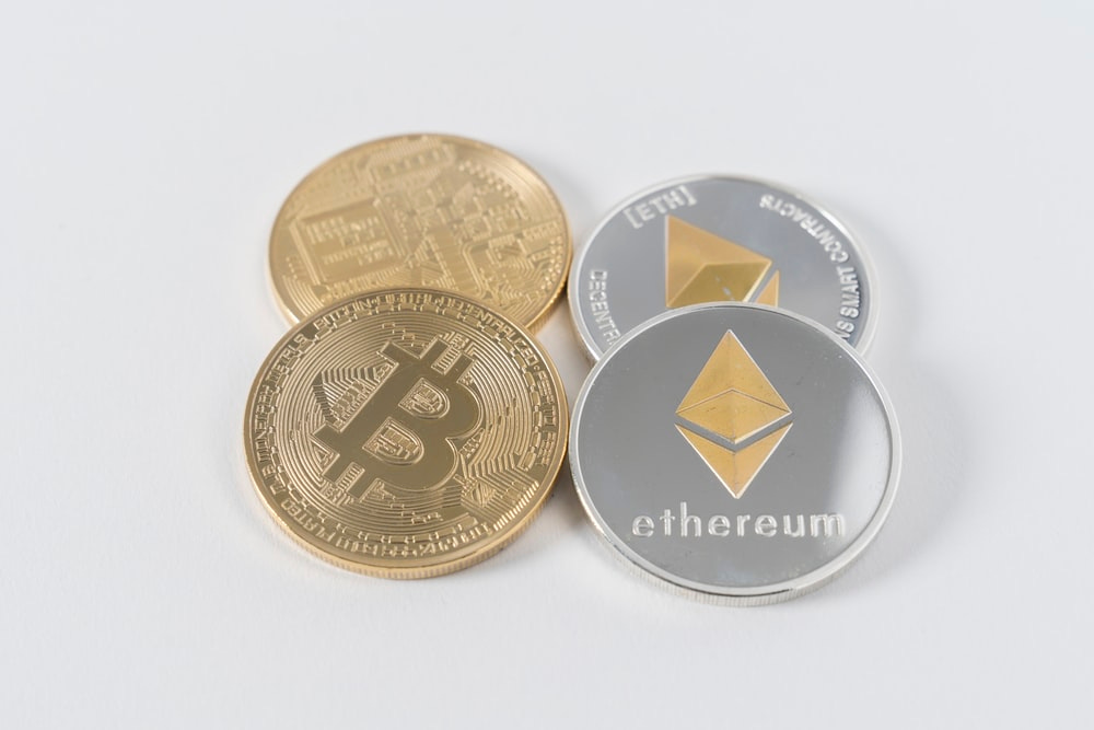 four round silver-colored and gold-colored Bitcoins four round silver-colored and gold-colored Bitcoins