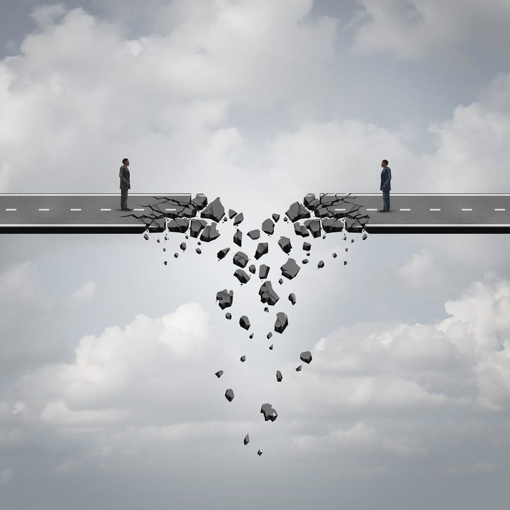 A crumbling road with people on either side