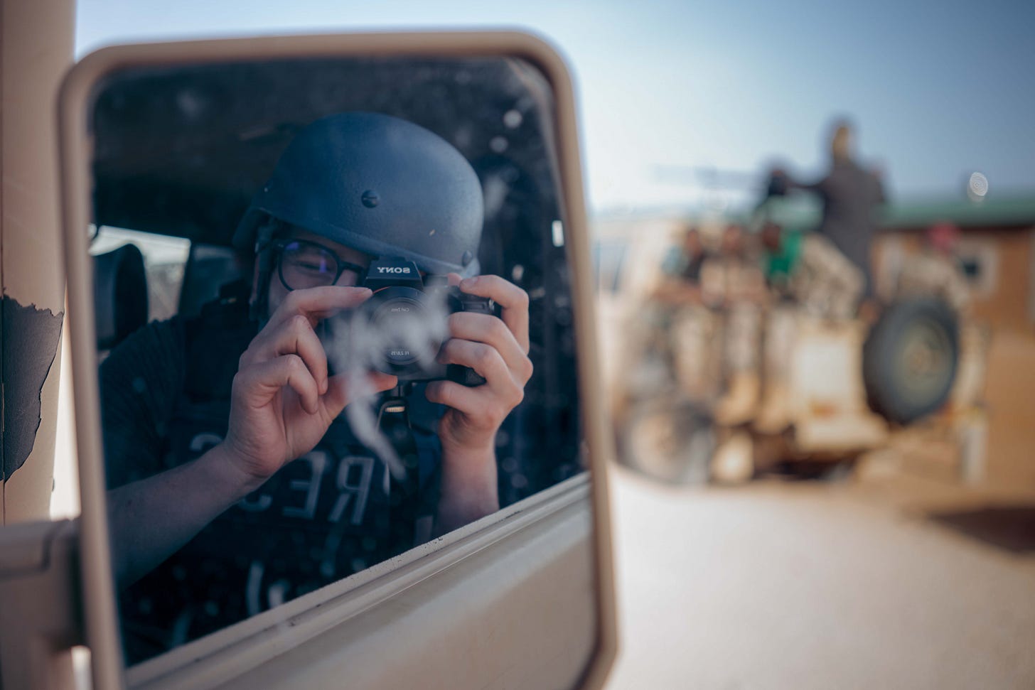 A man takes a photo of himself in a car's rearview mirror A man takes a photo of himself in a car's rearview mirror