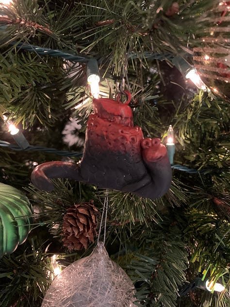 hand crafted ornaments for 2023 by Kayla Stark and Brad Henderson of a lion and a snail
