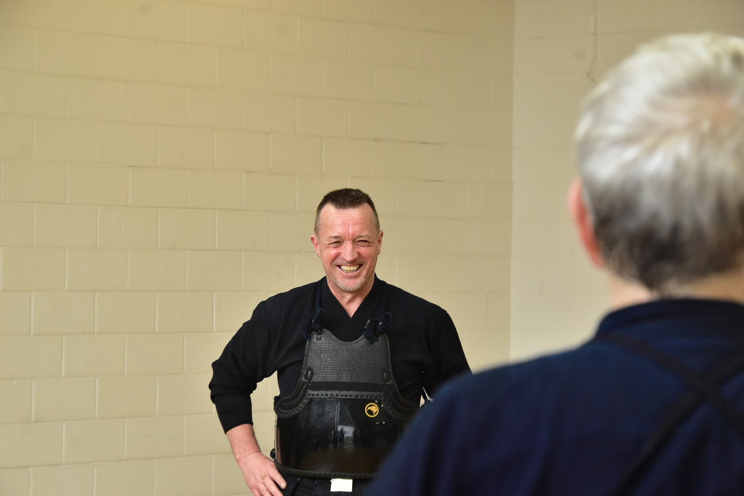 A person in black shirt and black vest

AI-generated content may be incorrect.