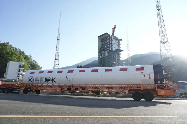 The Long March 2D's first-stage and fairing being handled at Launch Complex 3 ahead of flight.