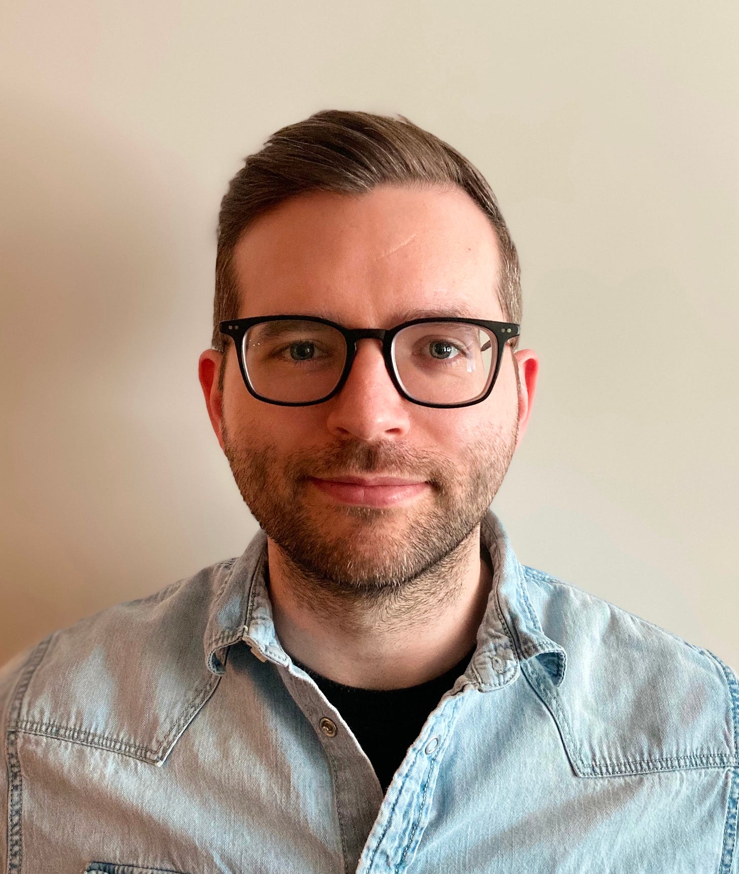 Author photo of Caleb Tankersley in a crisp denim shirt