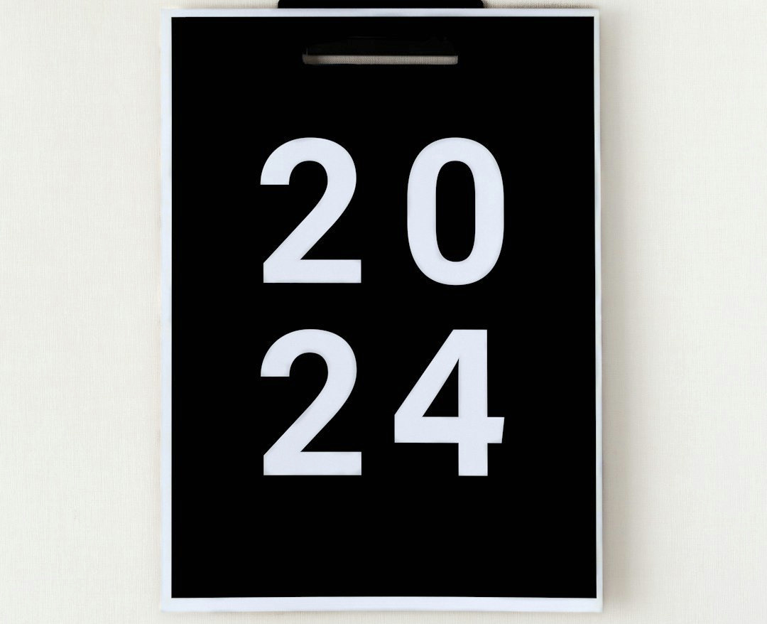 a black and white clock on a white wall a black and white clock on a white wall