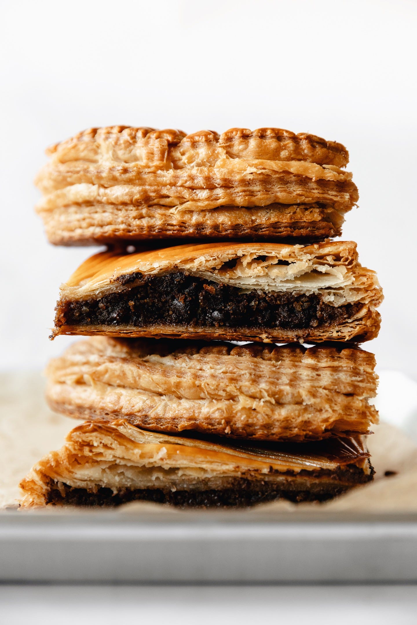Vegan chocolate bourbon pecan pithiviers cut in pieces and stacked up