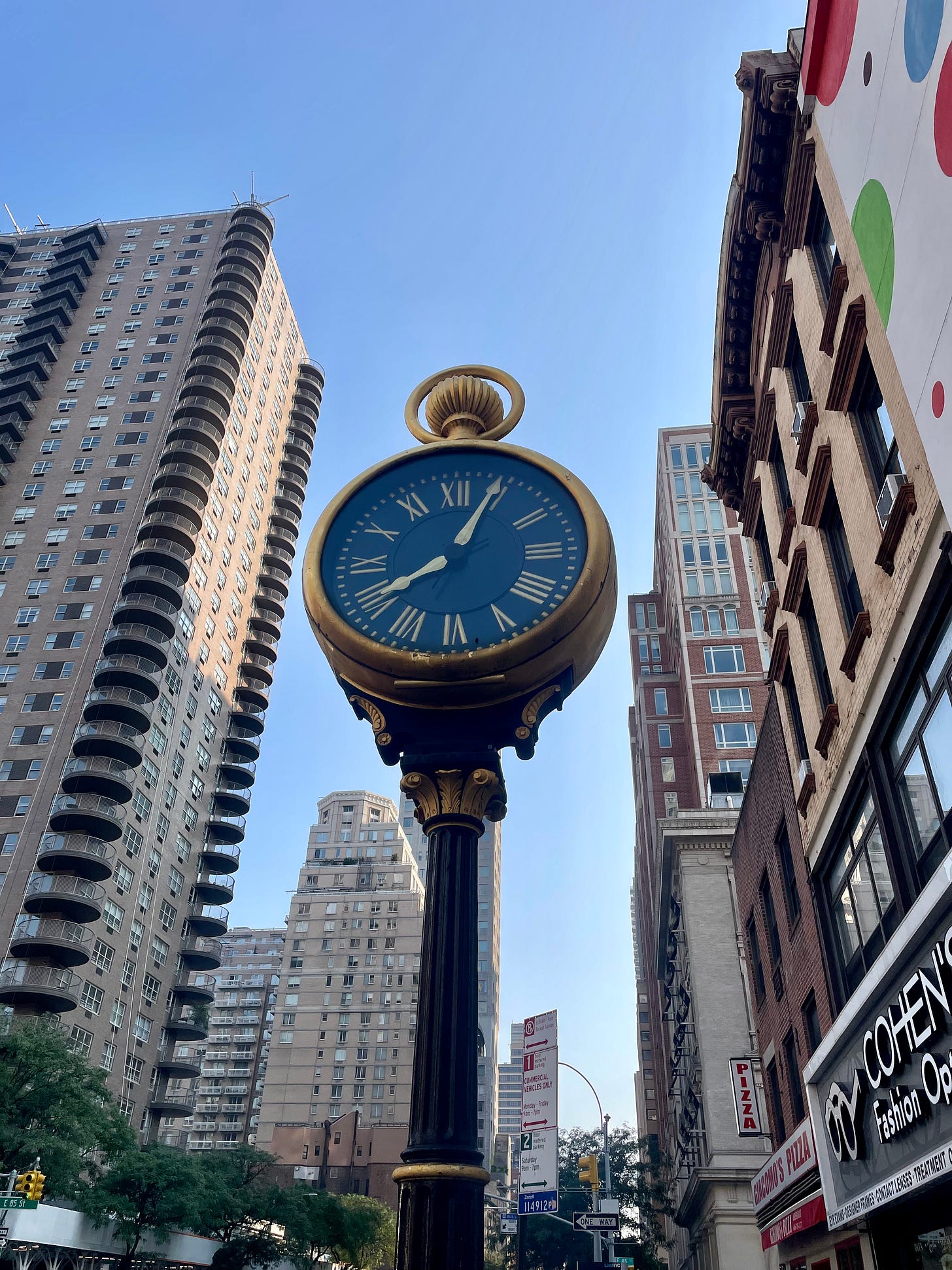 Pawnbroker's clock. The yorkville clock with buildings in background