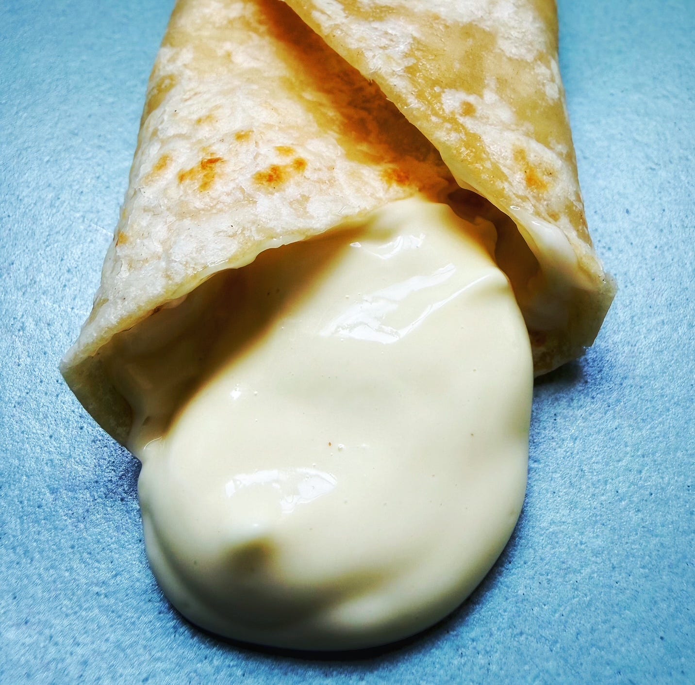 Flour tortilla filled with an alarming amount of mayo. Flour tortilla filled with an alarming amount of mayo.