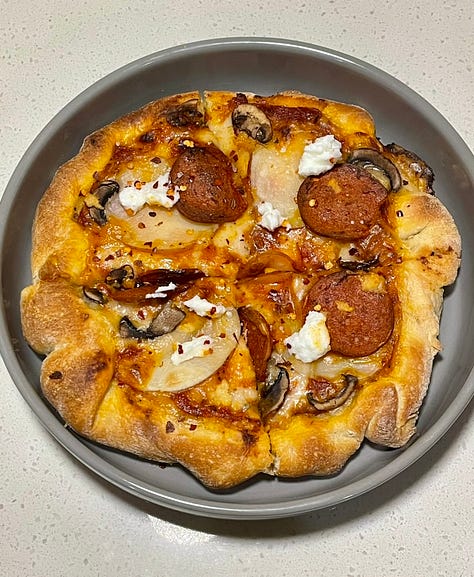 pizza dough on a counter, baked pizza sitting in a dutch oven, sliced pizza in a grey round bowl