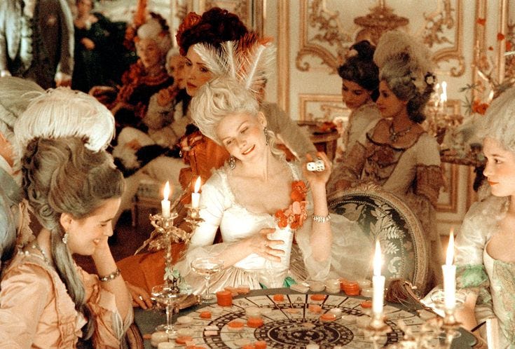 This may contain: a group of women sitting around a table with candles