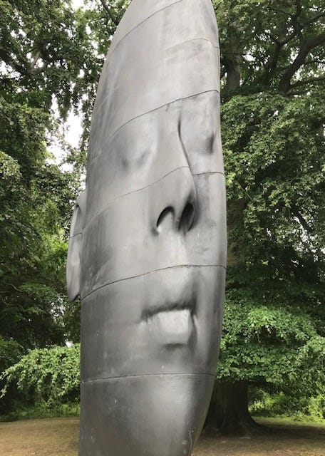 Large sculpture of a girl's head in Yorkshire Sculpture Park