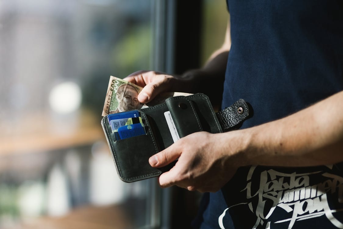 Free Photograph of Person Holding Black Leather Wallet with Money Stock Photo