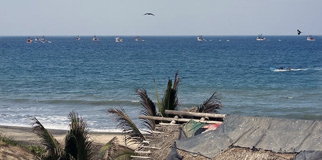 Slow travel discovers large fishing barcos off shore Slow travel discovers large fishing barcos off shore