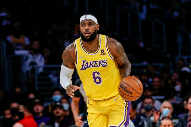 Los Angeles Lakers forward LeBron James (6) dribbles during the first half of a preseason NBA basketball game against the Golden State Warriors in Los Angeles, Tuesday, Oct. 12, 2021. (AP Photo/Ringo H.W. Chiu)