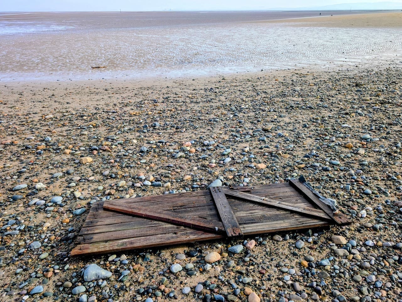 Old gate left as driftwood on the beach Old gate left as driftwood on the beach