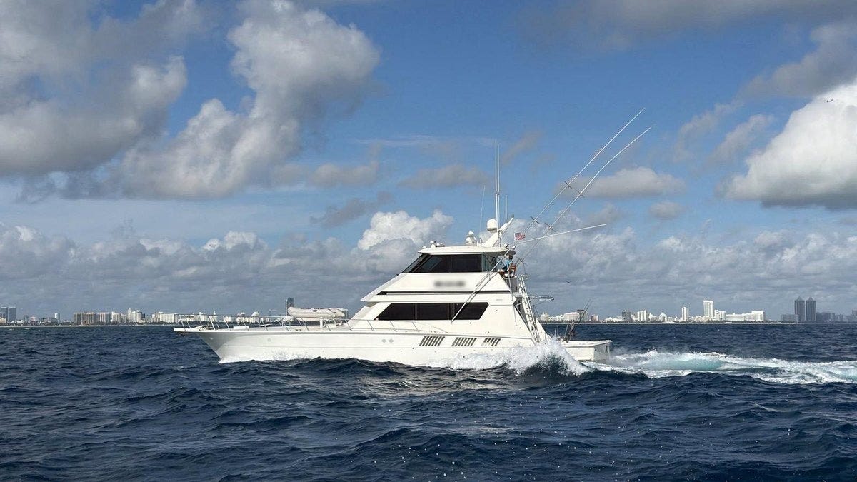 View of the pleasure craft used in this smuggling run as the Coast Guard escorts the vessel to a secure area in Miami to offload cocaine hidden aboard the vessel.