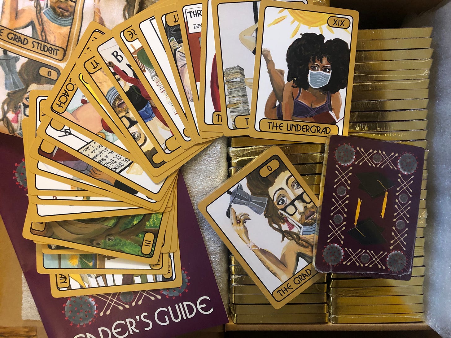 piles of academic tarot cards, with card 0 "The Grad Student" on top.