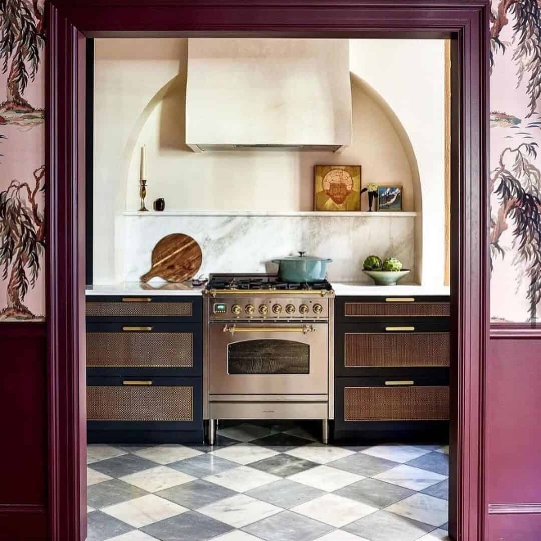 Kitchen with black and white tiled floor and purple walls. 