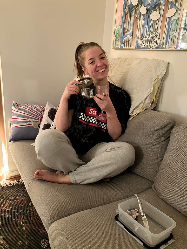 Kelly and Larissa healing on the couch with wine and comfy clothes.