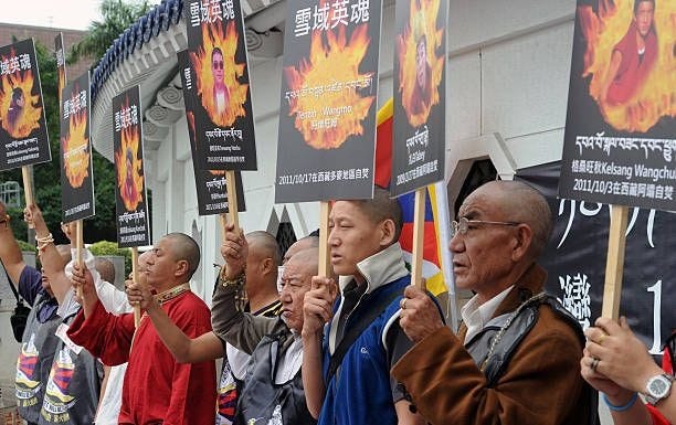 Tibetans display portraits of people who killed themselves in self-immolation, during a protest in front of the Liberty Square in Taipei on October...