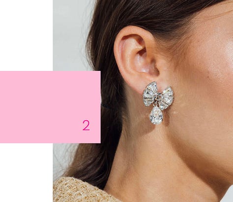 Women wearing crystal jewelry with pink accents. 