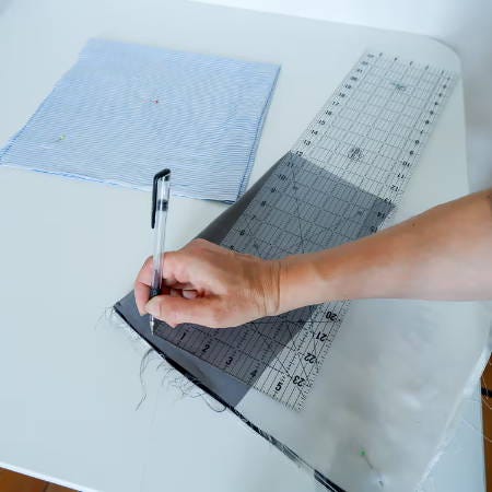 marking a circle with a black fabric marker and ruler on satin fabric marking a circle with a black fabric marker and ruler on satin fabric