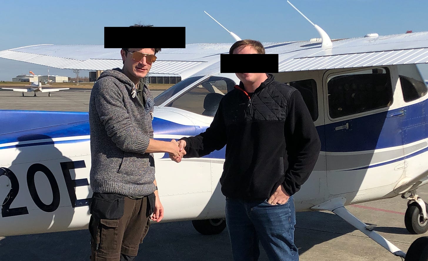 two men shaking hands in front of a small jet plane two men shaking hands in front of a small jet plane