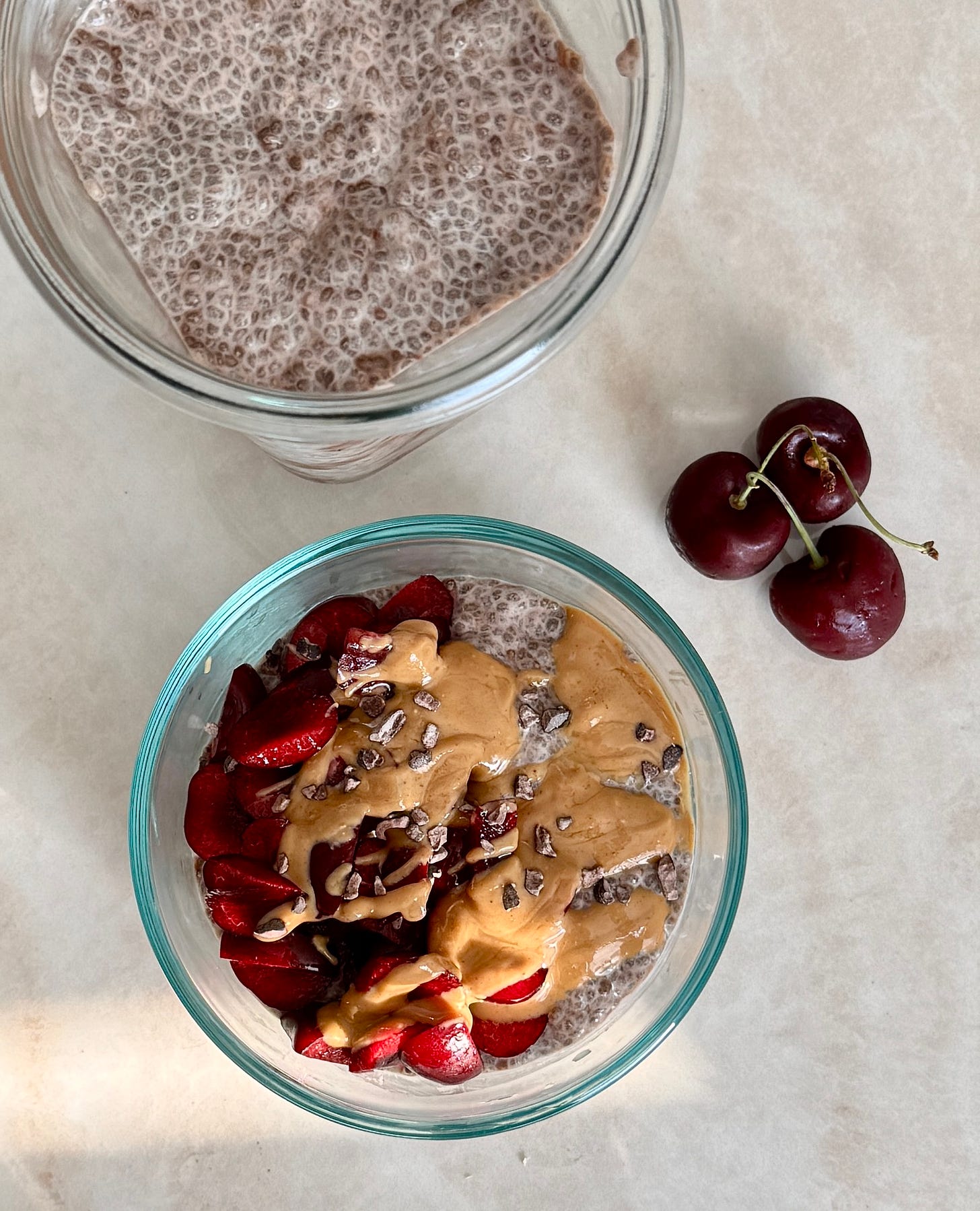 chocolate cherry chia pudding in glass jars