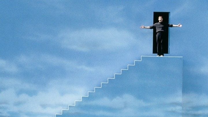 This may contain: a man standing on top of a stairway with his arms outstretched