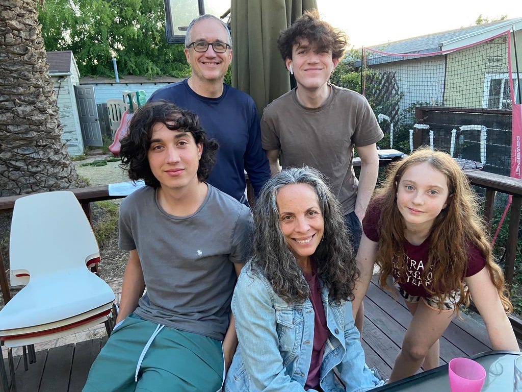 poet and three teenage kids plus husband outside at a picnic table poet and three teenage kids plus husband outside at a picnic table