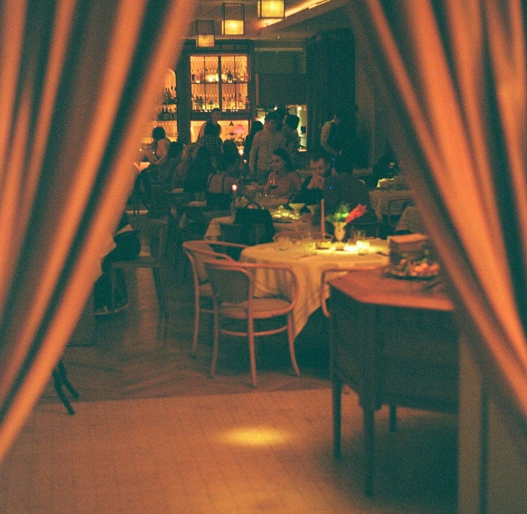 a group of people sitting at a table in a restaurant