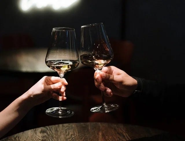 Toasting wine glass during anniversary date at home
