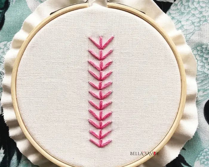 Fern Stitch Embroidery Tutorial 110 finished fern stitch in pink on hooped fabric