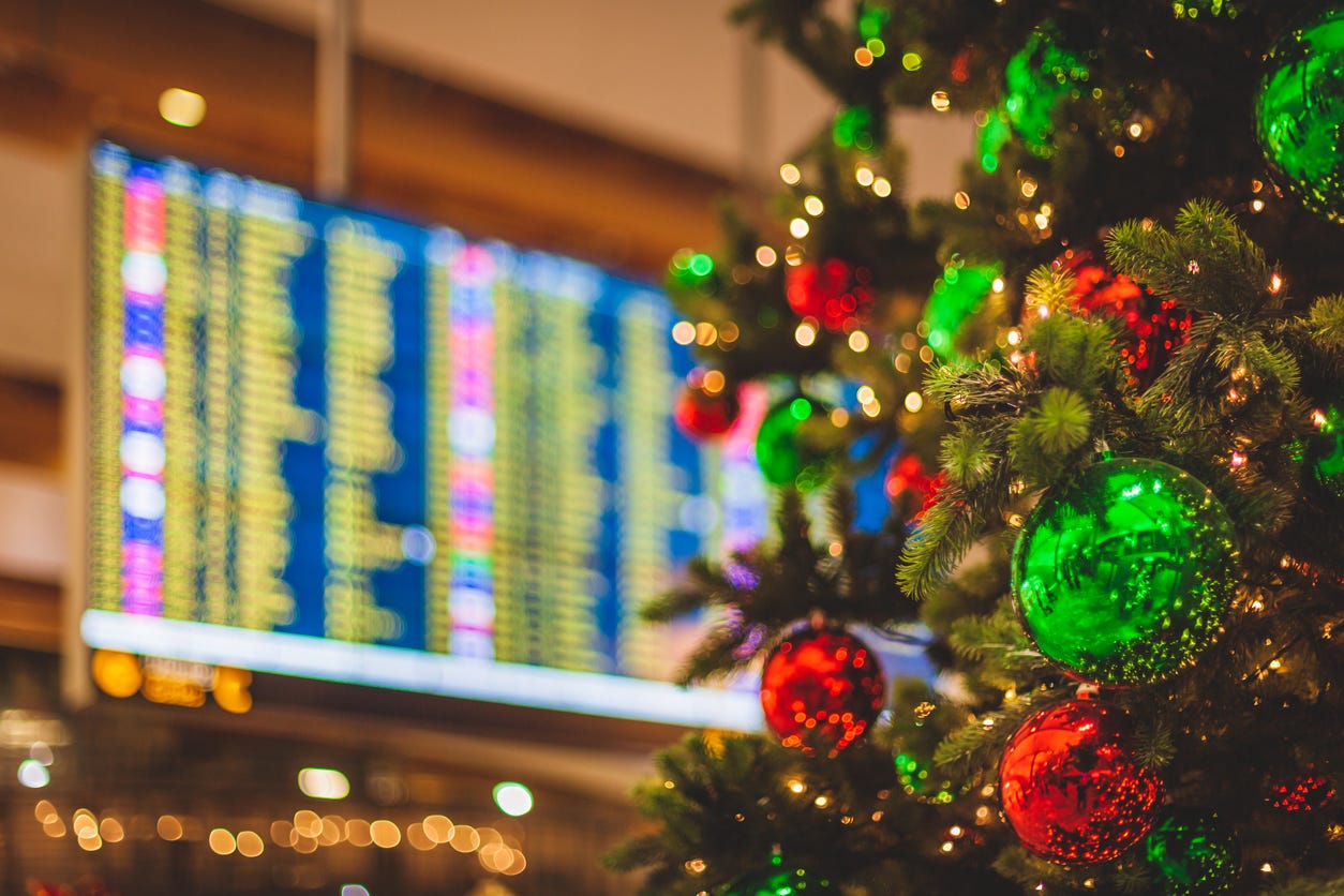 Christmas tree with red and green baubles and an airport screen in the background Christmas tree with red and green baubles and an airport screen in the background