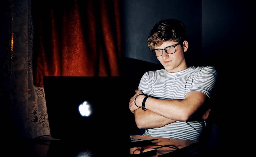 man looking at turned on MacBook