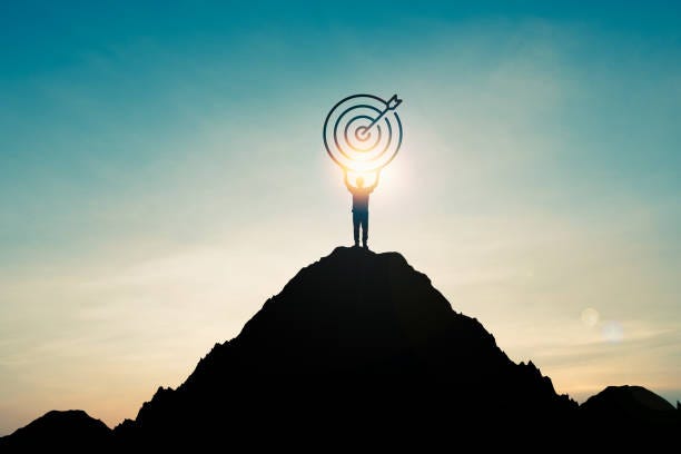 Silhouette Of Businessman Holding Target Board On The Top Of Mountain With  Over Blue Sky And Sunlight It Is Symbol Of Leadership Successful  Achievement With Goal And Objective Target Stock Photo -