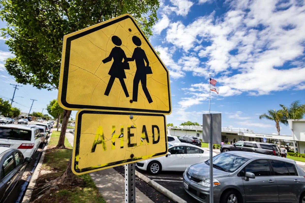 A pedestrian sign outside of an elementary school in Costa Mesa, Calif., on Aug. 21, 2023. (John Fredricks/The Epoch Times) A pedestrian sign outside of an elementary school in Costa Mesa, Calif., on Aug. 21, 2023. (John Fredricks/The Epoch Times)