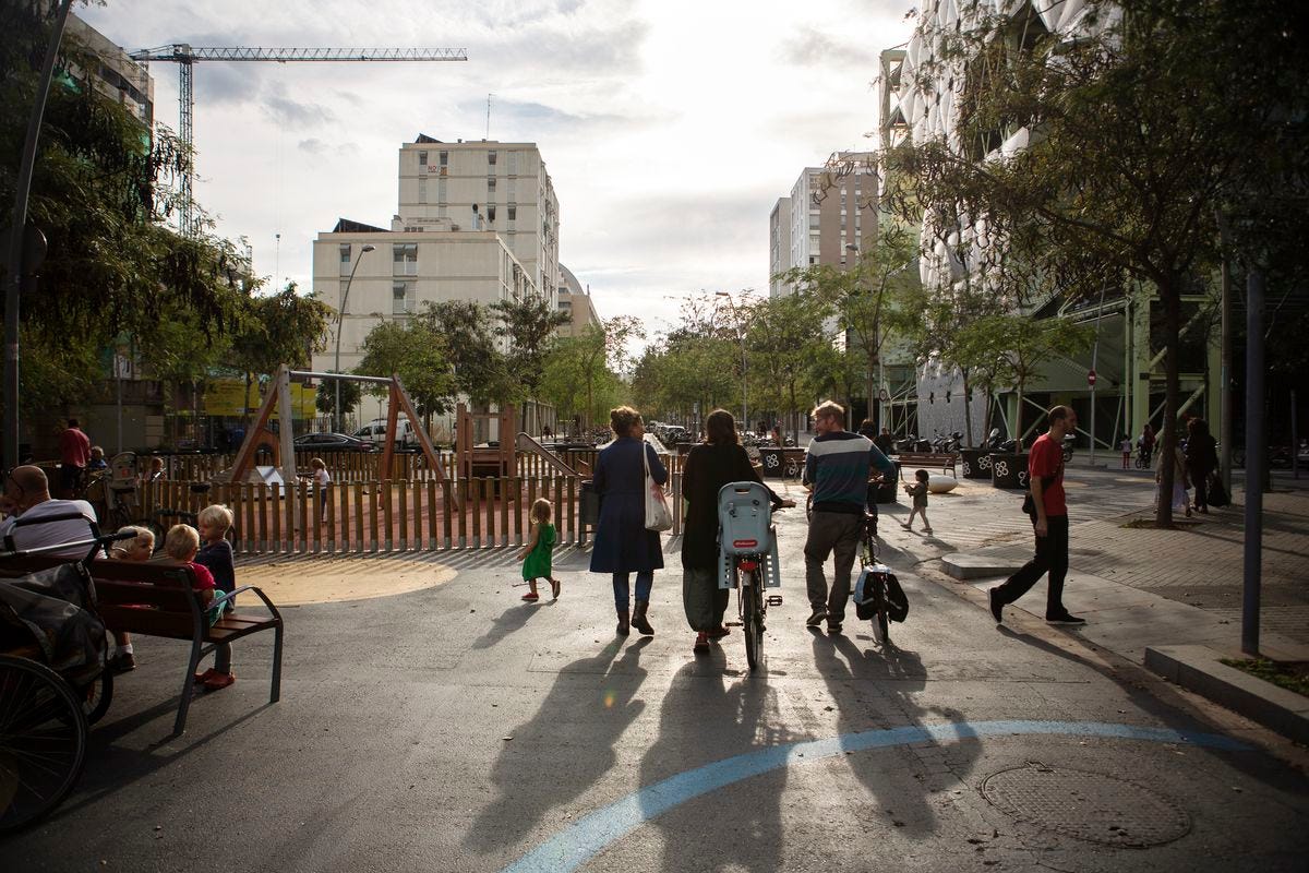 Silvia, Nora, and Patrick, neighbors and friends, chat in the Poblenou superblock. Taken October 15th, 2018. Barcelona, Catalonia, Spain. Silvia, Nora, and Patrick, neighbors and friends, chat in the Poblenou superblock. Taken October 15th, 2018. Barcelona, Catalonia, Spain.