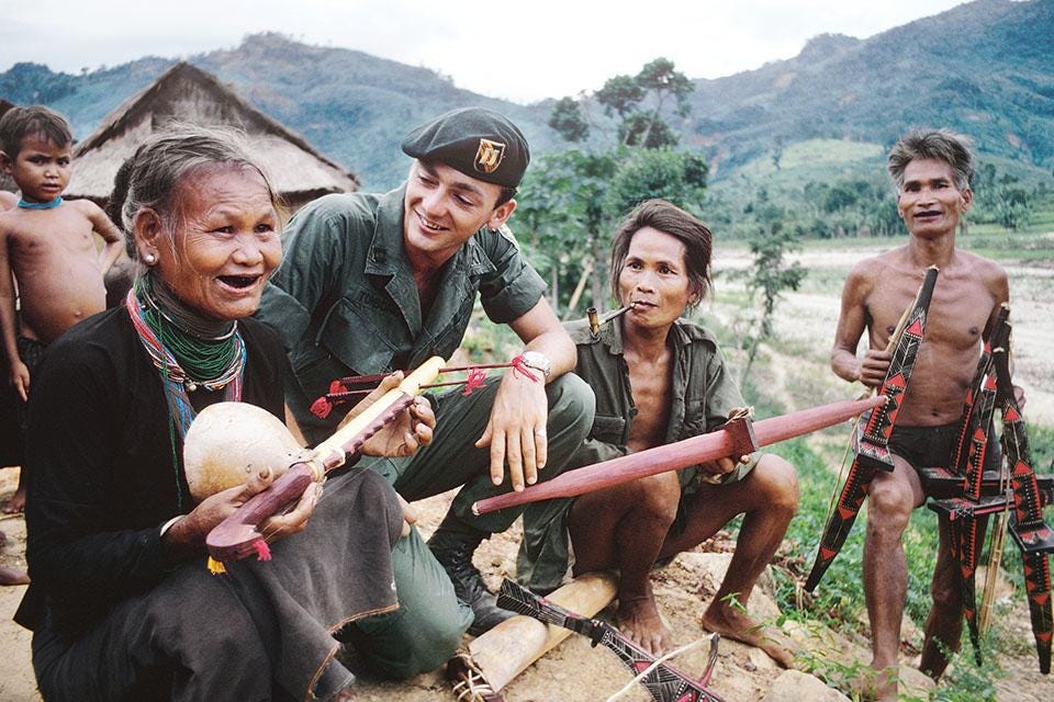 A group of people sitting on a hill

Description automatically generated