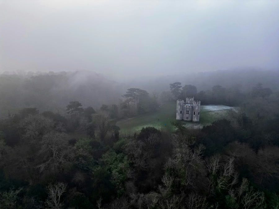 A castle (not Castle Drogo) wrapped in mist.