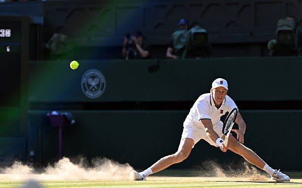 Italy's Jannik Sinner slips on the ground as he returns to Germany's Alexander Zverev during their men's singles final tennis match on the fourteenth...