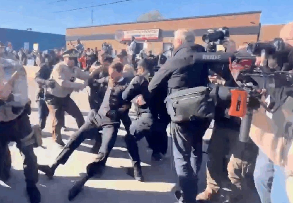 The Rev. Michael Woolf, center, is pulled from a group of demonstrators by police officers outside the U.S. Immigration and Customs Enforcement detention facility in Broadview, Illinois, Nov. 14.