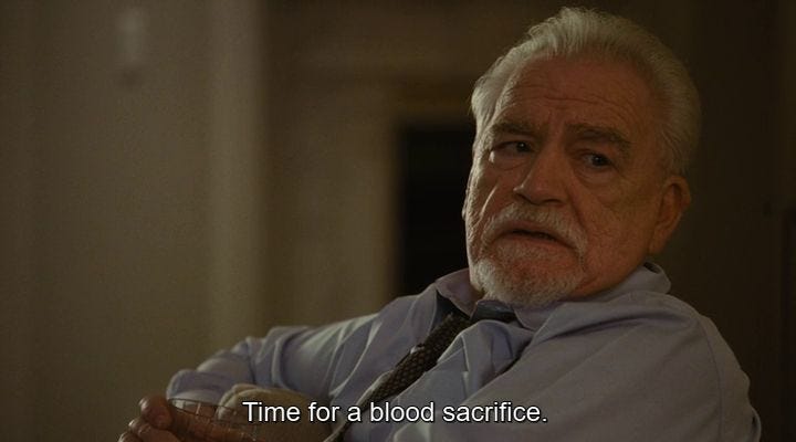 This may contain: an older man with white hair wearing a shirt and tie sitting in a chair looking off to the side