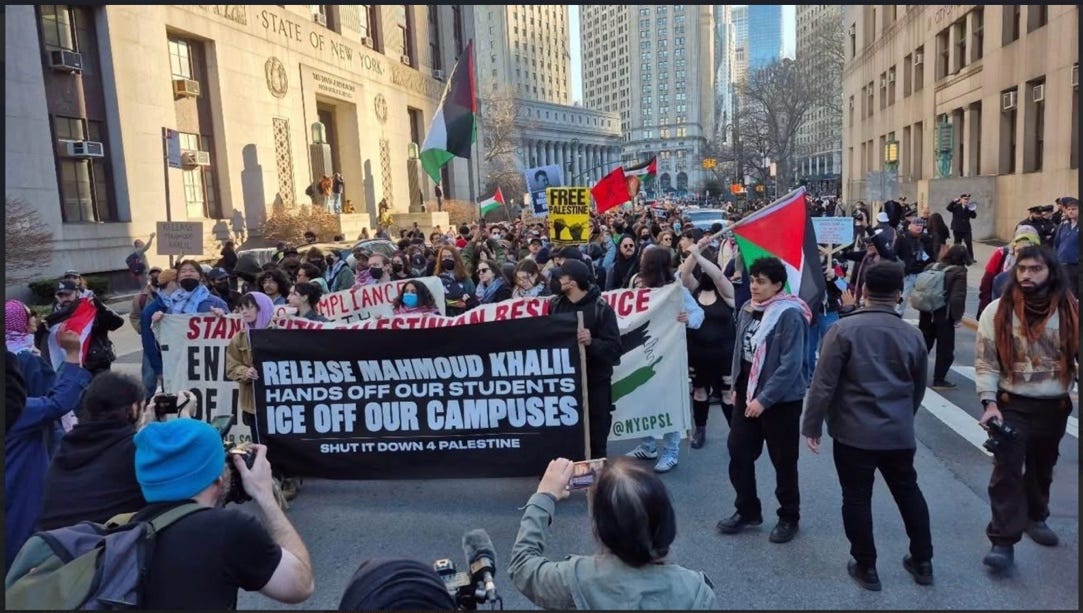 A group of people marching in a street

Description automatically generated