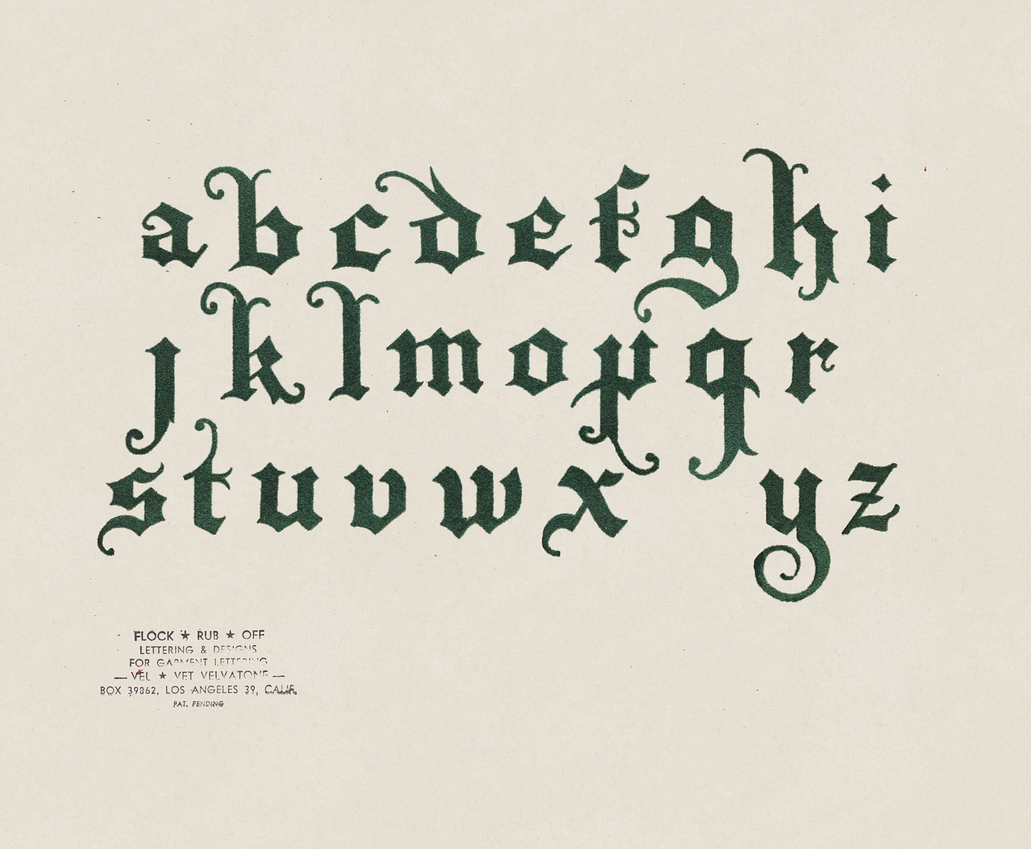 Green velvet-flocked Gothic alphabet on cream cardstock