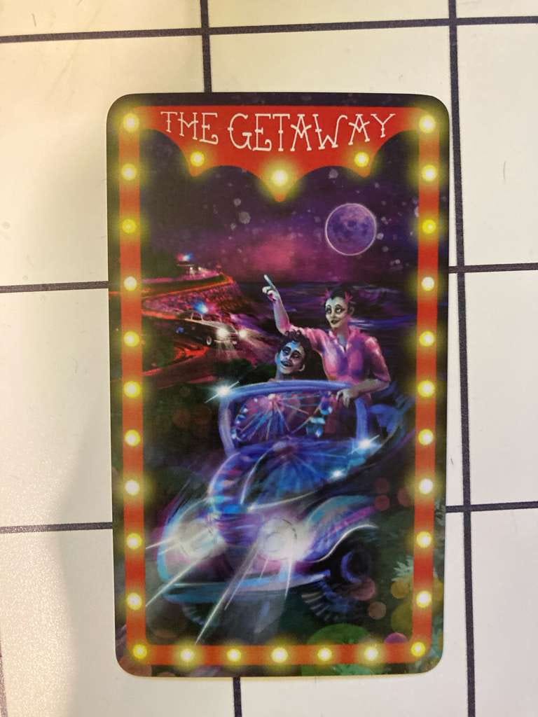 The Getaway card from the Charming Disaster Oracle Deck, showing a night-time escape by car The Getaway card from the Charming Disaster Oracle Deck, showing a night-time escape by car