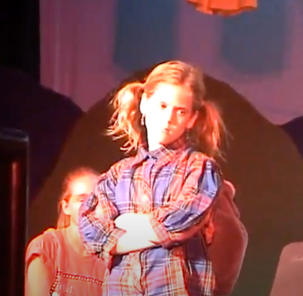 middle school Caroline on a theater stage with pigtails and an oversized plaid shirt middle school Caroline on a theater stage with pigtails and an oversized plaid shirt