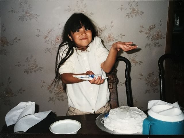 Me at 9ish-years-old shrugging and decorating a cake and having A LOT of bangs Me at 9ish-years-old shrugging and decorating a cake and having A LOT of bangs