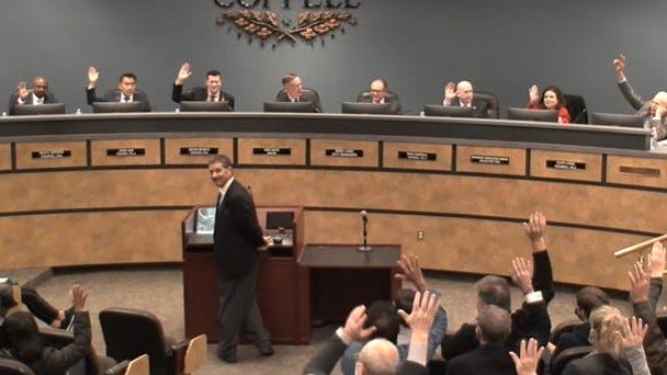 A room full of people raising their hands