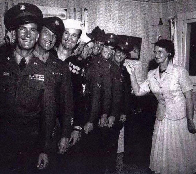 Emma Bushee, a proud mother, with her eight sons who all safely returned home after fighting in World War II, 1944.
