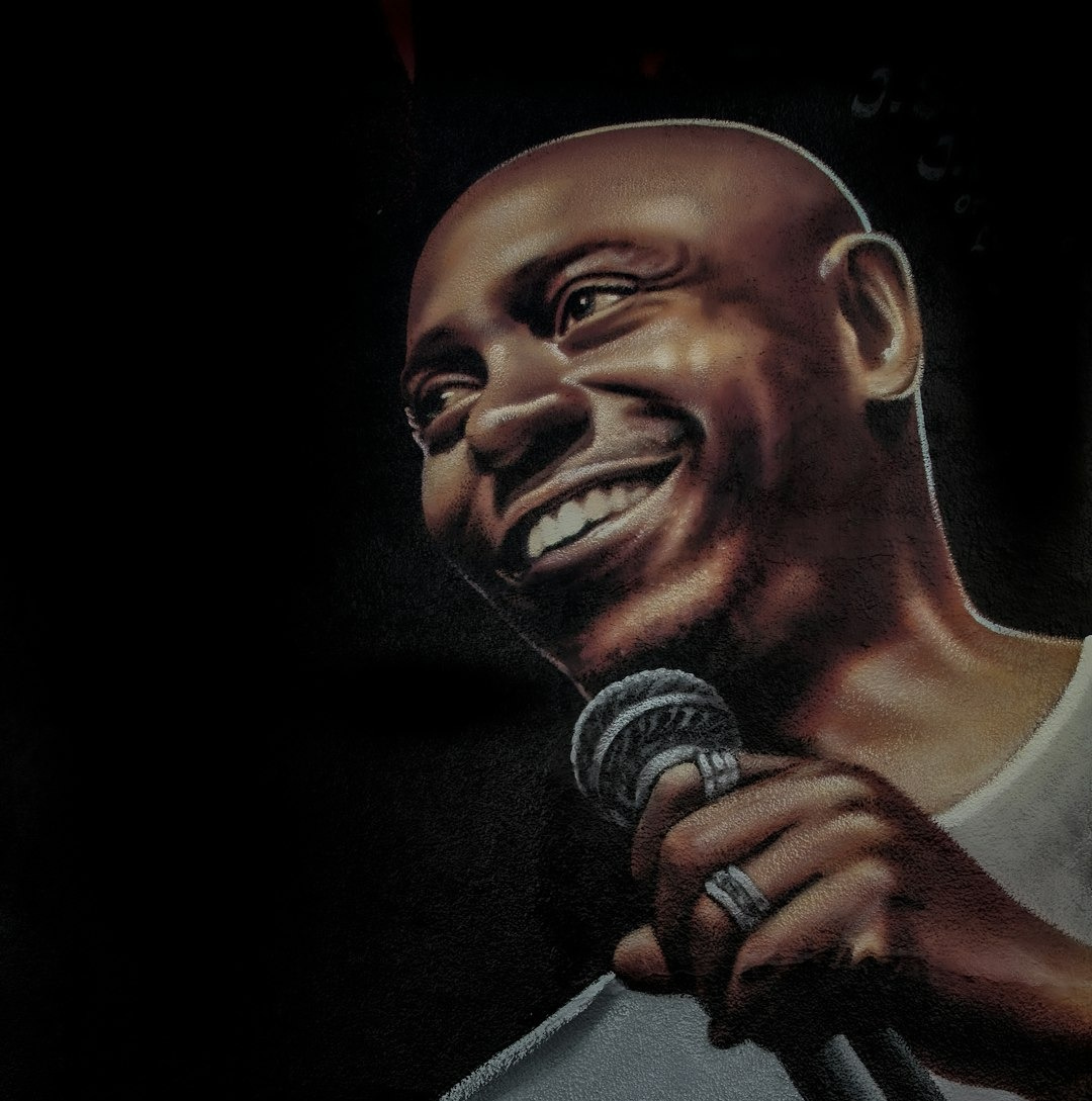 man in gray crew neck shirt holding microphone